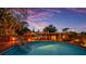 Beautiful pool with wooden deck, sunshades, and tranquil backyard setting at dusk at 1111 32Nd N St, St Petersburg, FL 33713