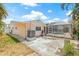 Backyard with patio, pool with enclosure, and exterior view of the back of the home at 1141 80Th Street S Ct, St Petersburg, FL 33707