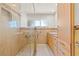 Modern bathroom features a large shower, neutral tile, and light wood cabinets at 1141 80Th Street S Ct, St Petersburg, FL 33707