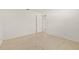 A bedroom with light carpet, white walls, and a partially open door at 1141 80Th Street S Ct, St Petersburg, FL 33707