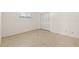A bedroom with a window, carpet, white walls, and a closet at 1141 80Th Street S Ct, St Petersburg, FL 33707