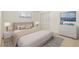 A bedroom with a large bed, carpet, window, and white dresser with a TV at 1141 80Th Street S Ct, St Petersburg, FL 33707