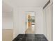 Entryway features black slate flooring transitioning into terrazzo, with a view into the kitchen and access to closet space at 1141 80Th Street S Ct, St Petersburg, FL 33707