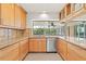 Updated kitchen with stainless steel appliances, granite countertops, and outdoor view at 1141 80Th Street S Ct, St Petersburg, FL 33707