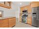 Bright kitchen features stainless steel appliances, light wood cabinets and granite countertops at 1141 80Th Street S Ct, St Petersburg, FL 33707