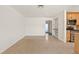 Open living room and kitchen with stainless steel appliances and tile flooring at 1141 80Th Street S Ct, St Petersburg, FL 33707