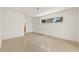 Spacious living room with neutral walls, terrazzo flooring, and a window providing natural light at 1141 80Th Street S Ct, St Petersburg, FL 33707