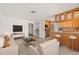 Open-concept living room and kitchen with modern furnishings and a breakfast bar at 1141 80Th Street S Ct, St Petersburg, FL 33707