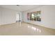 Open concept living room with tile flooring and view of landscaped backyard at 1141 80Th Street S Ct, St Petersburg, FL 33707