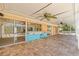 Outdoor covered patio with bar, ceiling fans, and access to the pool area at 1141 80Th Street S Ct, St Petersburg, FL 33707