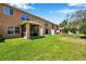 A spacious lawn behind a townhouse featuring a screened lanai and well maintained backyard at 11611 Mango Ridge Blvd, Seffner, FL 33584