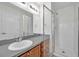 Bathroom with a gray countertop and a glass-enclosed shower area at 11611 Mango Ridge Blvd, Seffner, FL 33584