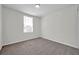 A simple bedroom with a window and carpet flooring at 11611 Mango Ridge Blvd, Seffner, FL 33584