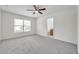 Spacious bedroom with a ceiling fan, large window, and an ensuite bathroom at 11611 Mango Ridge Blvd, Seffner, FL 33584