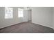 A bedroom featuring neutral walls, carpeted floors, a window, and a door leading to the hallway at 11611 Mango Ridge Blvd, Seffner, FL 33584