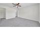 Large bedroom with a ceiling fan, closet and door leading to another room at 11611 Mango Ridge Blvd, Seffner, FL 33584