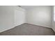 A bedroom featuring neutral walls, carpeted floors, and a closet with white sliding doors at 11611 Mango Ridge Blvd, Seffner, FL 33584