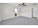 Bright bedroom featuring a ceiling fan and an attached bathroom, offering convenience at 11611 Mango Ridge Blvd, Seffner, FL 33584