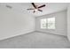 A bright bedroom with a ceiling fan and a window with bright sunlight at 11611 Mango Ridge Blvd, Seffner, FL 33584