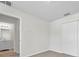 A bedroom with neutral walls, carpeted floors, and an ensuite bathroom with a vanity with light fixtures at 11611 Mango Ridge Blvd, Seffner, FL 33584