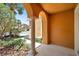 A covered entryway with an arched column offers a glimpse of the neighborhood at 11611 Mango Ridge Blvd, Seffner, FL 33584