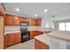 Updated kitchen features ample wood cabinetry, modern appliances, and granite countertops, a chef's dream at 11611 Mango Ridge Blvd, Seffner, FL 33584