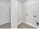 Bright laundry room with washer and dryer hookups, convenient shelving, and easy access storage at 11611 Mango Ridge Blvd, Seffner, FL 33584
