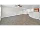 The living room is spacious with a ceiling fan and access to the dining room and kitchen at 11611 Mango Ridge Blvd, Seffner, FL 33584