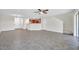 Open-concept living room boasts tile floors, ceiling fan, and natural light, perfect for entertaining guests at 11611 Mango Ridge Blvd, Seffner, FL 33584