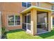 View of the screened patio with an air conditioning unit in the rear and a grass lawn at 11611 Mango Ridge Blvd, Seffner, FL 33584