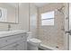 Updated bathroom with a stylish vanity, toilet, and shower featuring decorative tiling at 12400 Park Blvd # 210, Seminole, FL 33772