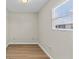 Empty room with hardwood floors, neutral paint, and natural light from a window at 12400 Park Blvd # 210, Seminole, FL 33772