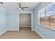 Bright bedroom featuring hardwood floors, a ceiling fan, and a window for natural light at 12400 Park Blvd # 210, Seminole, FL 33772