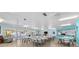 Large community room with tables, chairs, kitchen area, and plenty of natural light at 12400 Park Blvd # 210, Seminole, FL 33772