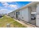 Exterior view of a single-story home with an attached carport and well-maintained lawn at 12400 Park Blvd # 210, Seminole, FL 33772