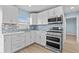 Updated kitchen features stainless steel appliances and tile backsplash at 12400 Park Blvd # 210, Seminole, FL 33772