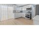 Kitchen featuring stainless steel appliances and white cabinetry at 12400 Park Blvd # 210, Seminole, FL 33772