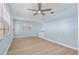 Bright living room featuring ceiling fan, and wood-look flooring at 12400 Park Blvd # 210, Seminole, FL 33772
