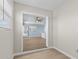 Open doorway leading to a bright living area with hardwood floors and large windows at 12400 Park Blvd # 210, Seminole, FL 33772