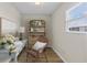 Cozy home office nook with desk, shelving, and a comfortable wicker chair near a window at 12400 Park Blvd # 210, Seminole, FL 33772