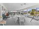 Spacious screened patio with tables, chairs, and a porch swing, ideal for outdoor relaxation and socializing at 12400 Park Blvd # 210, Seminole, FL 33772