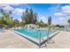 Community pool surrounded by lush landscaping and ample seating, providing a serene retreat at 12400 Park Blvd # 210, Seminole, FL 33772