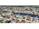 Aerial view of a canal-front home with docks and neighborhood, location marked by a red pin at 12700 5Th Isle, Hudson, FL 34667