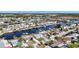 Scenic aerial view of a waterfront community with canals, docks, and beautiful homes under a clear blue sky at 12700 5Th Isle, Hudson, FL 34667