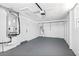 Spacious basement area with painted concrete floor, utility equipment, and white walls, perfect for storage or a workshop at 12700 5Th Isle, Hudson, FL 34667
