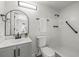 Clean, well-lit bathroom with modern fixtures, including a sleek vanity, toilet, and walk-in shower with safety bar at 12700 5Th Isle, Hudson, FL 34667