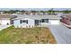 Charming single-story home with a well-manicured lawn and an attached garage at 12700 5Th Isle, Hudson, FL 34667
