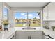 Bright kitchen with a stainless steel sink overlooking the backyard canal at 12700 5Th Isle, Hudson, FL 34667