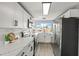 Modern kitchen with sleek white cabinets, stainless steel appliances, and a scenic view at 12700 5Th Isle, Hudson, FL 34667