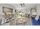 Well-lit open concept area with a stylish table and chairs alongside comfortable living space at 12700 5Th Isle, Hudson, FL 34667